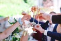 Hands holding glasses and toasting, happy festive moment Royalty Free Stock Photo