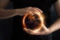 Hands holding global showing the world` s energy consumption. Royalty Free Stock Photo