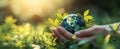 The hands holding a globe surrounded by vibrant green leaves in nature. AI generated image Royalty Free Stock Photo