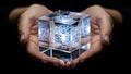 Hands holding a glowing cube representing technology and innovation in a dark setting Royalty Free Stock Photo
