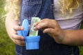 Hands holding a gold coin. Money in the toilet. money in a toilet bowl Royalty Free Stock Photo