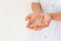 Hands holding gold ribbon on white background with copy space. The international awareness symbol for Childhood Cancer. World Royalty Free Stock Photo