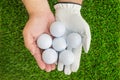 Hands holding 6 golf balls Royalty Free Stock Photo