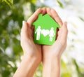 Hands holding green house with family Royalty Free Stock Photo