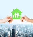 Hands holding green house with family Royalty Free Stock Photo