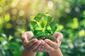 Hands holding a green recycling symbol with fresh leaves, concept for eco-friendliness and sustainability Royalty Free Stock Photo