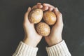 Hands holding hand painted easter eggs on black background, top view shot Royalty Free Stock Photo