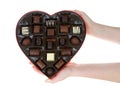 Hands holding heart box with chocolate candies, isolated Royalty Free Stock Photo