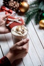 Hands holding heart shape cookie and cup of coffee Royalty Free Stock Photo