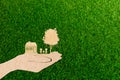 Hands holding home family tree and car grass background Royalty Free Stock Photo