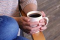 hands holding hot cup of coffee or tea in morning sunlight Royalty Free Stock Photo