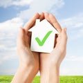 Hands holding house with check mark Royalty Free Stock Photo