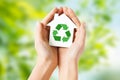 Hands holding house with green recycling sign Royalty Free Stock Photo