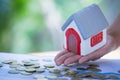 Hands holding a  house model. Housing industry mortgage plan and residential tax saving strategy, mortgage, investment, real Royalty Free Stock Photo