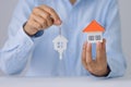 Hands holding a  house model. Housing industry mortgage plan and residential tax saving strategy, mortgage, investment, real Royalty Free Stock Photo