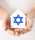 Hands holding house with star of david Royalty Free Stock Photo