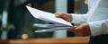The hands holding important papers in a modern office environment.AI generated image Royalty Free Stock Photo