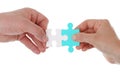 Hands holding and joining two pieces of puzzle together isolated.Teamwork partnership cooperation and matching concept Royalty Free Stock Photo