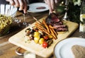 Hands Holding Knife and Fork Getting Food From Dish