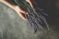 Hands Holding Lavender Bouquet Flowers on Rustic Dark Background