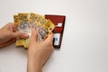 Hands holding leather wallet with australian dollars 50 banknotes. Finance concept with copy space