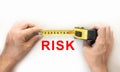 Hands holding measure tape measuring risk Royalty Free Stock Photo