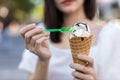 Hands holding melting ice cream waffle cone in hands on summer light nature background Royalty Free Stock Photo