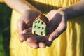 Hands holding model of house