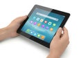 Hands holding a modern tablet device displaying a colorful array of application icons on its screen Royalty Free Stock Photo