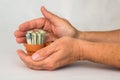 Hands holding money in a terracotta pot Royalty Free Stock Photo