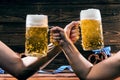 Hands holding mugs of Bavarian beer Oktoberfest.