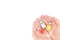 Hands holding multiple covid-19 vaccine vials isolated in white background. Hope concept, top view with copy space.