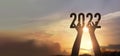Hands holding of new year 2022 silhouette against on the sunset background, Happy New Year concept Royalty Free Stock Photo