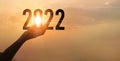 Hands holding of new year 2022 silhouette against on the sunset background, Happy New Year concept Royalty Free Stock Photo