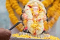 Hands Holding or offering incense or agarbatti stick in front of lord vinayaka or Ganesha while praying or worshiping Royalty Free Stock Photo