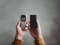 Hands holding old phone and new smartphone. Evolution, technology concept. Great for technology, progress, history, future themes Royalty Free Stock Photo