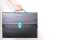 Hands Holding an old and ruined Technical Black Briefcase Royalty Free Stock Photo