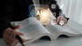 Hands Holding Open Book with Artificial Intelligence Concept and Digital Icons Representing Technology, Learning, and Royalty Free Stock Photo