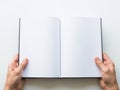 Hands holding open book with blank pages isolated on white background Royalty Free Stock Photo
