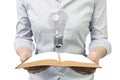 Hands holding open book with light bulb Royalty Free Stock Photo