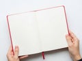 Hands holding open red notebook Royalty Free Stock Photo