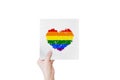 Hands holding paper with heart shape LGBTQ color, Isolated on white.