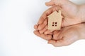 hands holding paper house, family home, homeless housing, mortgage crisis and home protecting insurance concept, foster