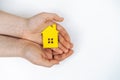 hands holding paper house, family home, homeless housing, mortgage crisis and home protecting insurance concept, foster
