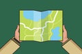 Hands holding paper map. Folded map in hands of men. Tourist look at map. Vector Illustration in flat design. Travel Royalty Free Stock Photo
