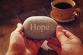 Hands holding pebble stone with the word hope Royalty Free Stock Photo