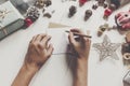hands holding pencil and writing a letter wish list to santa claus with space for text. merry christmas and happy new year. child Royalty Free Stock Photo