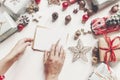 hands holding pencil and writing a letter wish list to santa claus flat lay with space for text. merry christmas and happy new ye Royalty Free Stock Photo