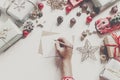 hands holding pencil and writing a letter wish list to santa claus with space for text. merry christmas and happy new year. child Royalty Free Stock Photo