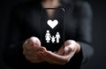 Hands holding a phone with family icon Royalty Free Stock Photo